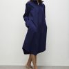 The Mela Purdie Half Zip Dress French Navy features a zip through the collar and curved hemline. It also has long sleeves and a midi length.