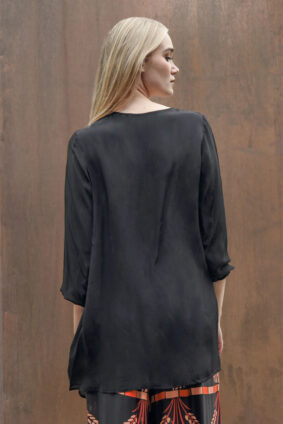 Plain back view of the Curate World of Wonders scoop neck top showing the lightweight drape of the viscose fabric.
