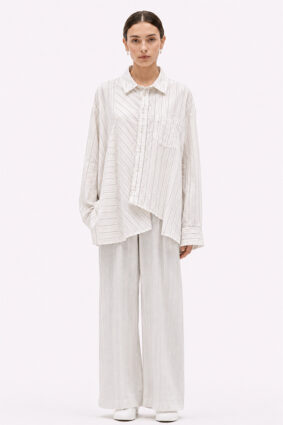 Off-white relaxed fit shirt by La Vaca Loca featuring a unique diagonal front closure and chest pocket.