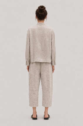 La Vaca Loca Salvd loose-fit asymmetrical shirt in cold white distressed cotton voile fabric with a stand-up collar.