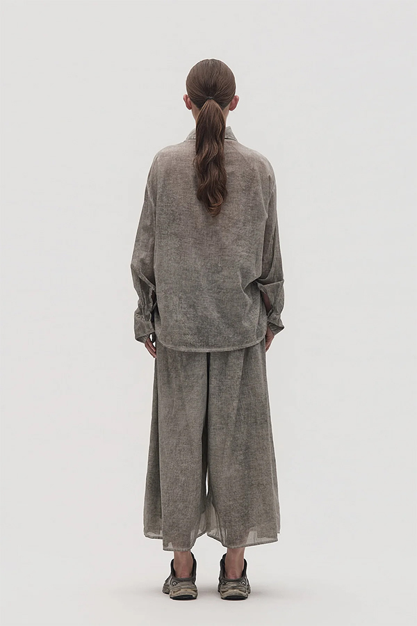 La Vaca Loca Somatico oversized long-sleeved shirt in cold black voile fabric with irregular front gathers.