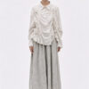 The La Vaca Loca Somatico Shirt Cold White CW is a long-sleeved shirt with a collar and textured, irregular gathers on the front, made of soft voile fabric.