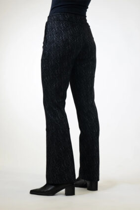Woman wearing Lisette Onyx Crosshatch Mini Flair ankle-length pants in Black Charcoal with a dark long-sleeve knit top