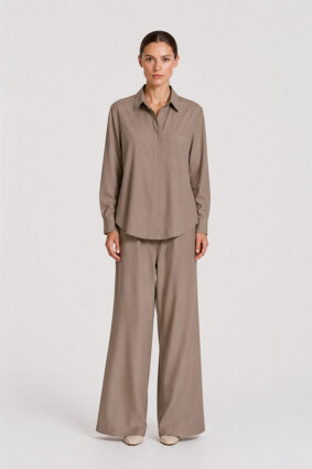 Model wearing Mela Purdie Suit Pant in Almond with a matching long-sleeve blouse.