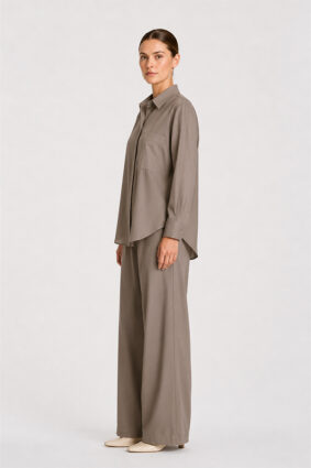 Model wearing Mela Purdie Suit Pant in Almond with a matching long-sleeve blouse.