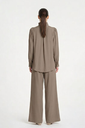 Model wearing Mela Purdie Suit Pant in Almond with a matching long-sleeve blouse.