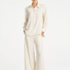 Model wearing Mela Purdie Suit Pant in Vanilla and Black fine vertical stripes.