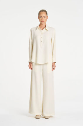 Model wearing Mela Purdie Suit Pant in Vanilla and Black fine vertical stripes.