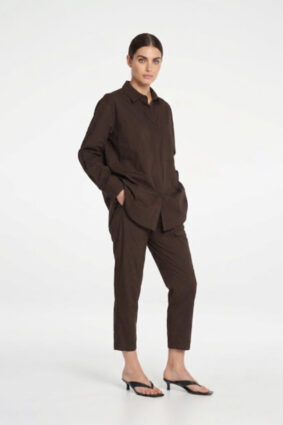 Model wearing Mela Purdie Zip Tapered Pant in Fudge brown with matching blouse.