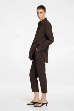 Model wearing Mela Purdie Zip Tapered Pant in Fudge brown with matching blouse.