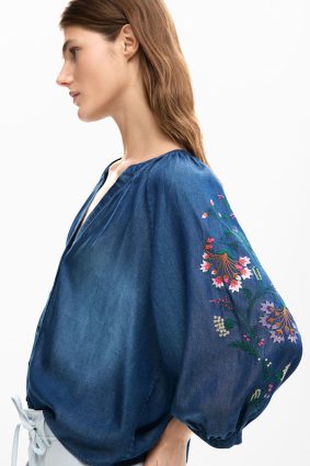 Desigual Embroidered Balloon Blouse Azul Marea front view showing soft washed blue fabric and flowing silhouette