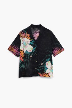 Desigual Tropical Shirt Negro front view showing relaxed resort-inspired silhouette and open collar with vibrant tropical print of oversized florals and lush palm leaves