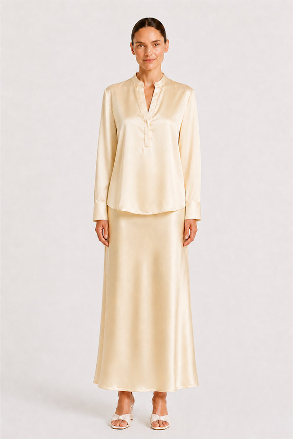 Blouse Mozarella elegant soft off-white silk blouse with a refined split neckline, fluid drape, and wide cuffs.