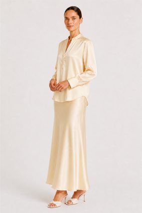 Blouse Mozarella elegant soft off-white silk blouse with a refined split neckline, fluid drape, and wide cuffs.