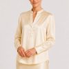 Blouse Mozarella elegant soft off-white silk blouse with a refined split neckline, fluid drape, and wide cuffs.