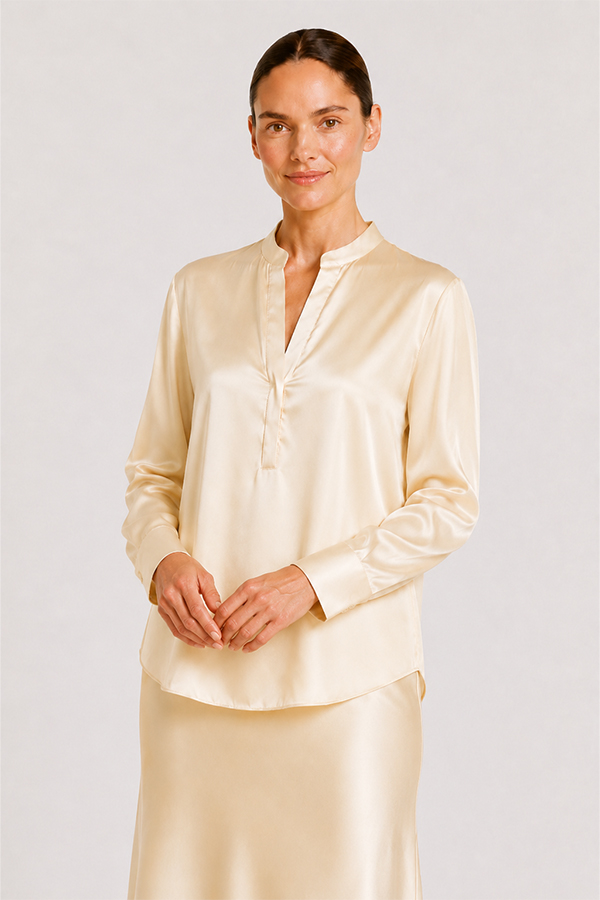 Blouse Mozarella elegant soft off-white silk blouse with a refined split neckline, fluid drape, and wide cuffs.