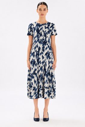 Model wearing the High Tech Mesmerize Dress 002, featuring an elegant shaded natural print, crewneck, and an irregular hem.