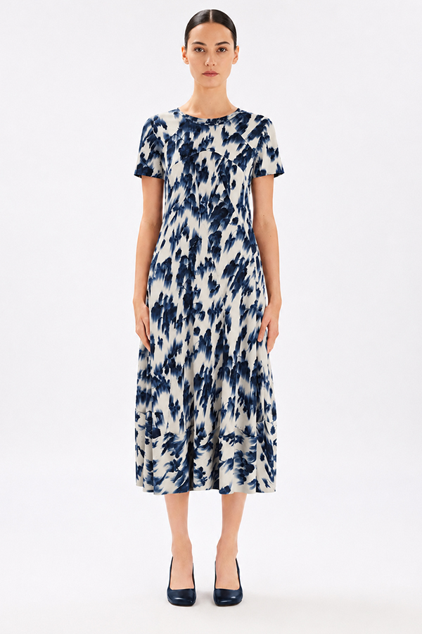 Model wearing the High Tech Mesmerize Dress 002, featuring an elegant shaded natural print, crewneck, and an irregular hem.