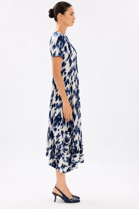 Model wearing the High Tech Mesmerize Dress 002, featuring an elegant shaded natural print, crewneck, and an irregular hem.