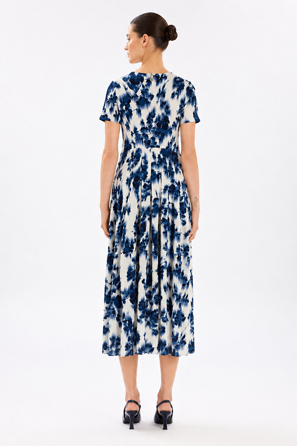 Model wearing the High Tech Mesmerize Dress 002, featuring an elegant shaded natural print, crewneck, and an irregular hem.