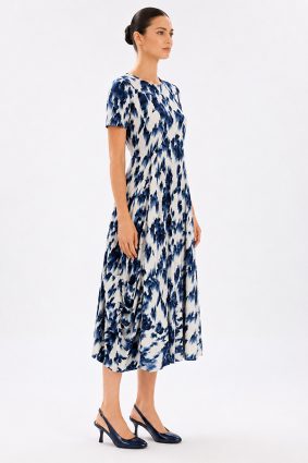 Model wearing the High Tech Mesmerize Dress 002, featuring an elegant shaded natural print, crewneck, and an irregular hem.