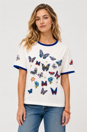 Johnny Was Contrast Binding T-Shirt Vanny in white featuring blue contrast neck and sleeve binding with embroidered butterflies and floral motifs.