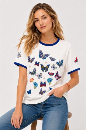 Johnny Was Contrast Binding T-Shirt Vanny in white featuring blue contrast neck and sleeve binding with embroidered butterflies and floral motifs.