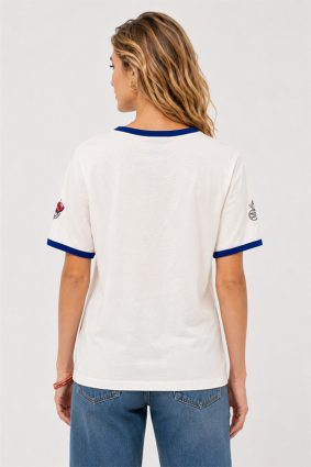 Johnny Was Contrast Binding T-Shirt Vanny in white featuring blue contrast neck and sleeve binding with embroidered butterflies and floral motifs.