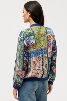 Johnny Was Kim Bomber Jacket Armeria, a luxurious reversible bomber jacket featuring vibrant patchwork-inspired prints, contrasting ribbed trims, and rich jewel-toned floral details.