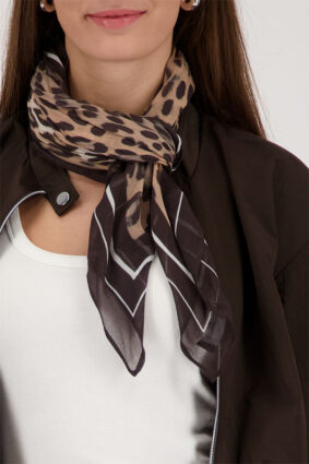 Monari sand-colored leopard print leglet scarf featuring a bold feline motif worn by a model.