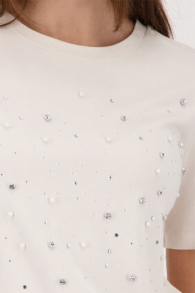 Monari soft beige short sleeve t-shirt with a flattering silhouette worn by a model.