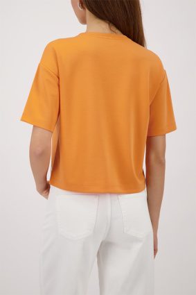 Monari jersey top in warm aperitif orange featuring crystal embellishments and patch pocket detail