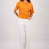 Monari jersey top in warm aperitif orange featuring crystal embellishments and patch pocket detail