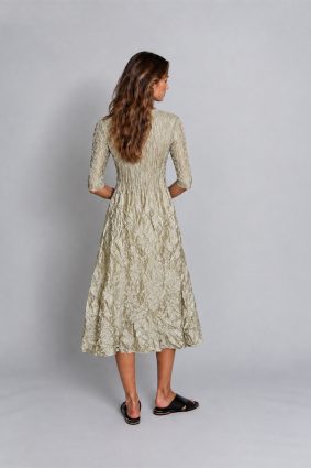 Alquema 3/4 sleeve pleated midi dress in glossy platinum with side pockets and round neckline