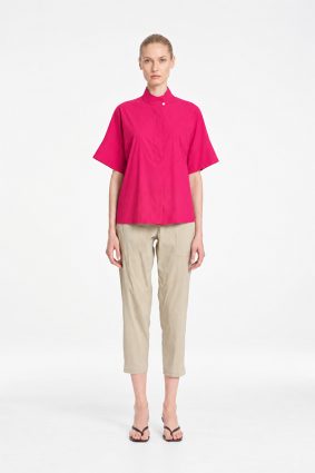Mela Purdie Tab Shell top in vibrant raspberry featuring a relaxed silhouette, stand collar, and short sleeves