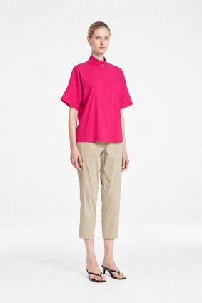 Mela Purdie Tab Shell top in vibrant raspberry featuring a relaxed silhouette, stand collar, and short sleeves