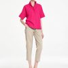 Mela Purdie Tab Shell top in vibrant raspberry featuring a relaxed silhouette, stand collar, and short sleeves