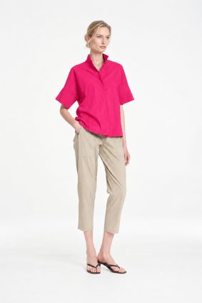 Mela Purdie Tab Shell top in vibrant raspberry featuring a relaxed silhouette, stand collar, and short sleeves