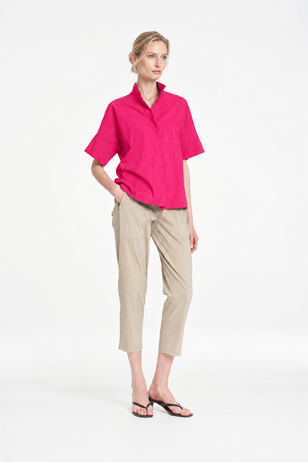Mela Purdie Tab Shell top in vibrant raspberry featuring a relaxed silhouette, stand collar, and short sleeves
