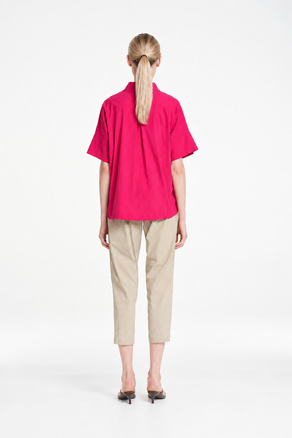 Mela Purdie Tab Shell top in vibrant raspberry featuring a relaxed silhouette, stand collar, and short sleeves