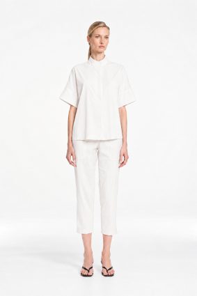 Mela Purdie Tab Shell top in crisp white featuring a relaxed silhouette, stand collar, and short sleeves
