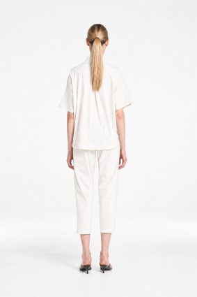 Mela Purdie Tab Shell top in crisp white featuring a relaxed silhouette, stand collar, and short sleeves