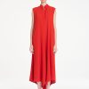 Mela Purdie Tab Soire Dress in vibrant papaya featuring a fluid silhouette, stand collar, open neckline, and asymmetric handkerchief hem