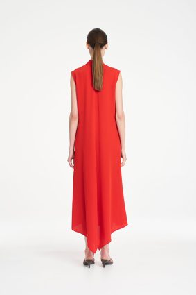 Mela Purdie Tab Soire Dress in vibrant papaya featuring a fluid silhouette, stand collar, open neckline, and asymmetric handkerchief hem