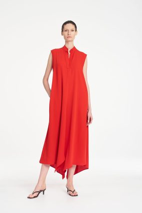Mela Purdie Tab Soire Dress in vibrant papaya featuring a fluid silhouette, stand collar, open neckline, and asymmetric handkerchief hem