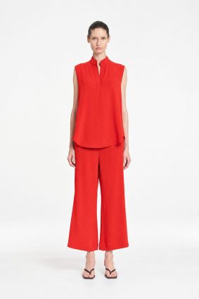 Mela Purdie Tabbard Tank in vibrant papaya featuring a sophisticated sleeveless style, relaxed fluid silhouette, stand collar, and open neckline