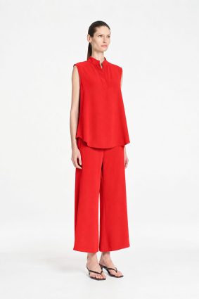 Mela Purdie Tabbard Tank in vibrant papaya featuring a sophisticated sleeveless style, relaxed fluid silhouette, stand collar, and open neckline