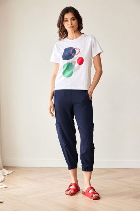 Peruzzi Circle Print T Shirt White featuring a colourful abstract navy, green, and red circle print against a white base.