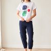 Peruzzi Circle Print T Shirt White featuring a colourful abstract navy, green, and red circle print against a white base.