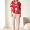 Peruzzi Polka Dot Cotton Top Red featuring a bold red and cream polka dot print with a relaxed silhouette and feminine tie detailing at the cuffs.